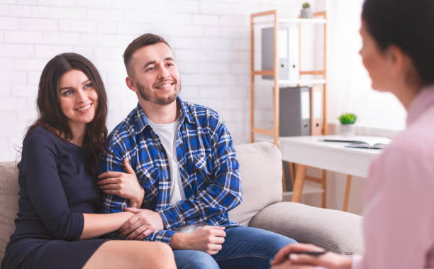Couple Engages in Discussion With Counselor in Modern Office Setting