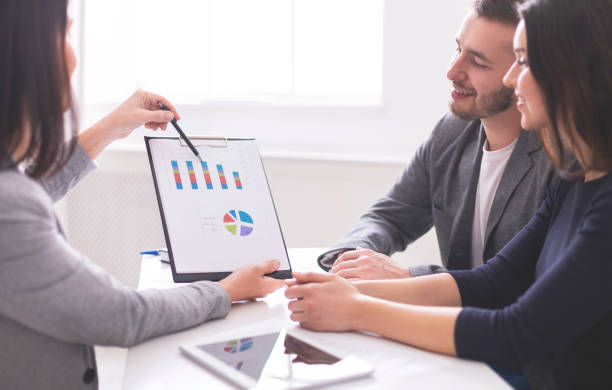 istock Business Professionals Discussing Financial Data During a Meeting at a Modern Office 2195157490