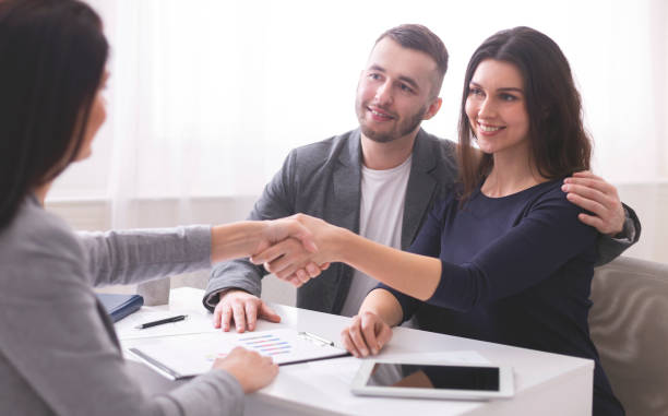 istock Couple Engaged in Discussion With Advisor During Important Meeting in Modern Office Setting 2195157493