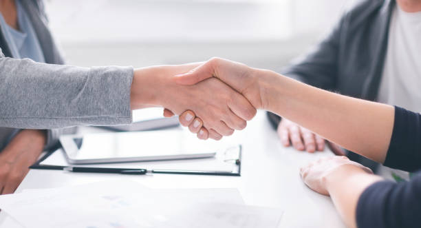 istock Business Professionals Engage in a Handshake During a Meeting in a Modern Office Setting 2195157499