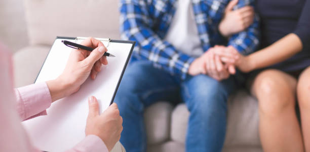 istock Couple Engaged in Therapy Session With Psychologist in Cozy Setting 2195157515