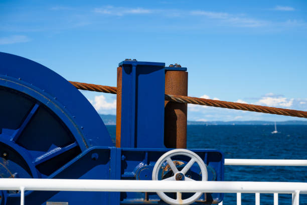 Rusty metal wire on a blue wire drum on a ferry.