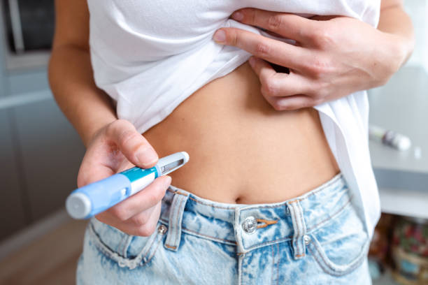 istock Person administering insulin injection using a pen 2195157778