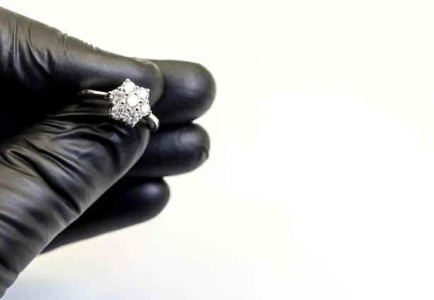 Hand with black glove and a diamond ring