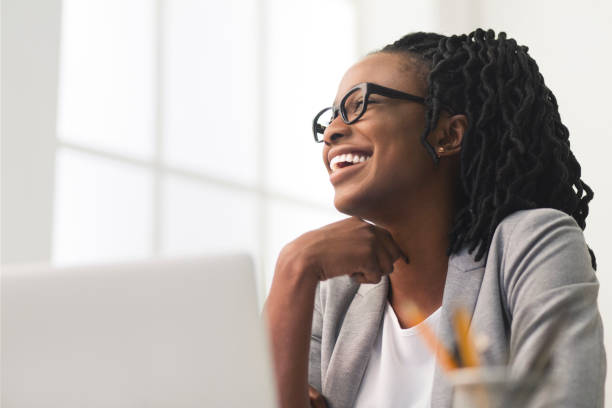 istock Smiling Afro Business Woman Sitting On Workplace 2195160321