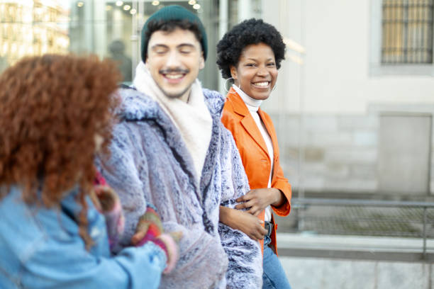 istock Three young adults smiling and walking in the city 2195166166