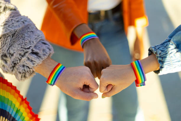 istock Young activists showing rainbow bracelets at pride parade 2195166197