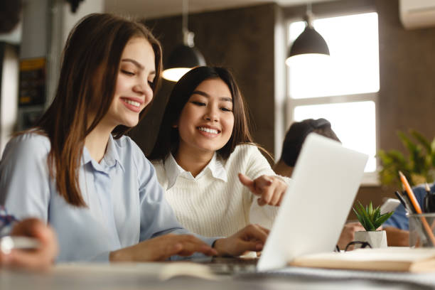 istock Education concept. Happy students with laptop in library 2195167561