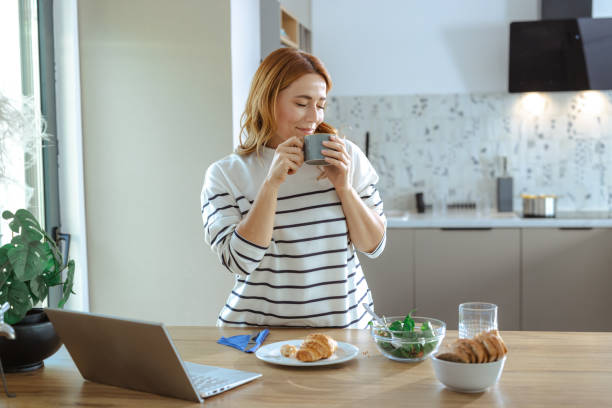 istock Woman enjoying a coffee break in a modern kitchen with healthy snacks 2195168035
