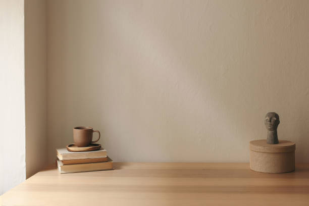 istock Artistic boho still life. Cup of tea, coffee, old books. Boho busta sculpture, statue. Round textile gift box. Beige wall background mockup. Empty copy space. Elegant minimal interior living room. 2195168510