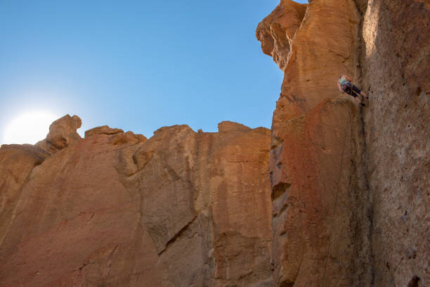 A single rock climber scales a rock wall at Smith Rock State Park in Oregon