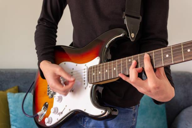 istock Close up of hands playing guitar 2195173024