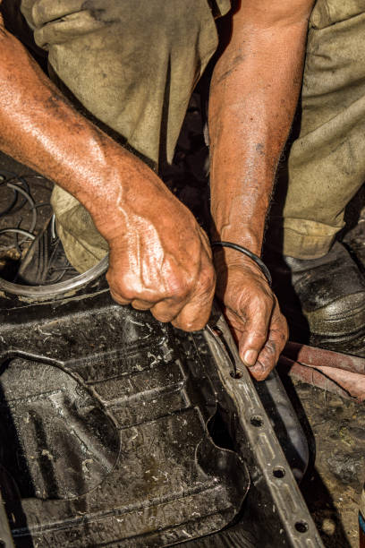 Close Up of Mechanic's Hands Working on Oil Pan