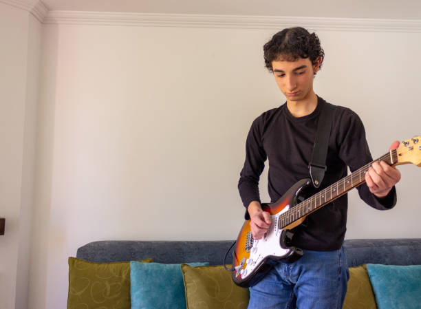 istock Young musician practice guitar 2195173502