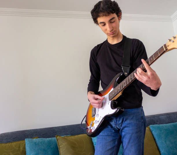 istock Young musician practice guitar 2195173516