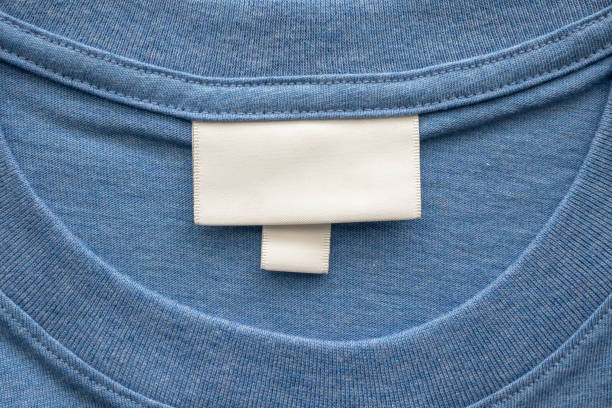 istock Blank white laundry care clothes label on blue shirt fabric texture background 2195175033