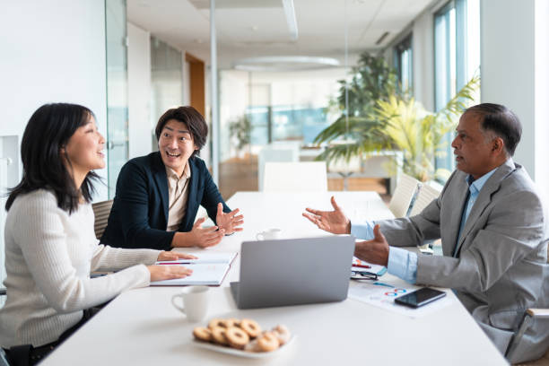 istock Professional Financial Advisor Meets With Asian Clients In Modern Office 2195175556