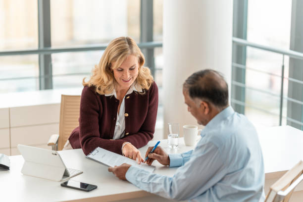 istock Professional Financial Advisor And Client Review Documents In Modern Office 2195175578