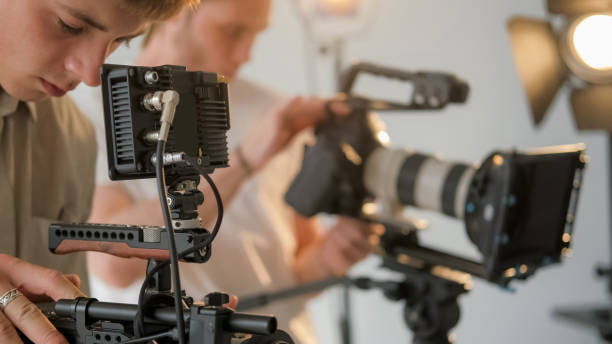 istock Cameraman backstage videographer team studio film 2195175724