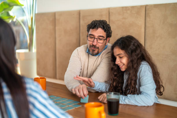 istock Joyful Hispanic Family Enjoying Puzzle Activity Together 2195175794