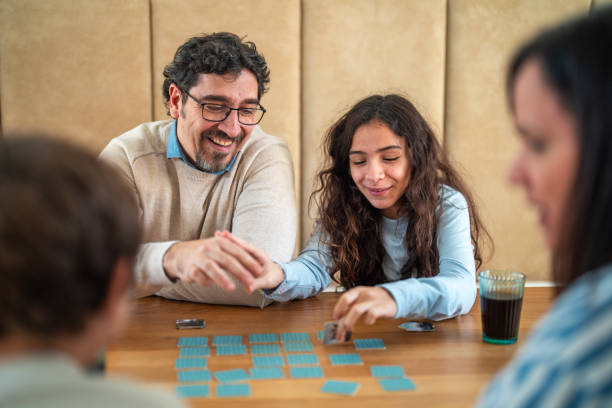 istock Joyful Hispanic Family Enjoying Puzzle Game Together 2195175872