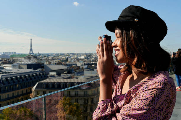 istock Woman with photo camera with the Eiffel tower in the background 2195181544