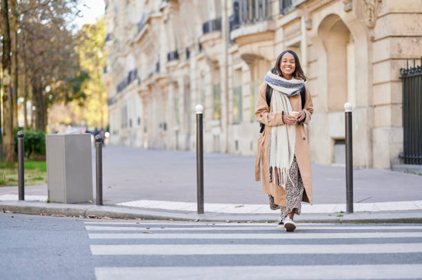 istock Woman with coffee walking down the street 2195182625
