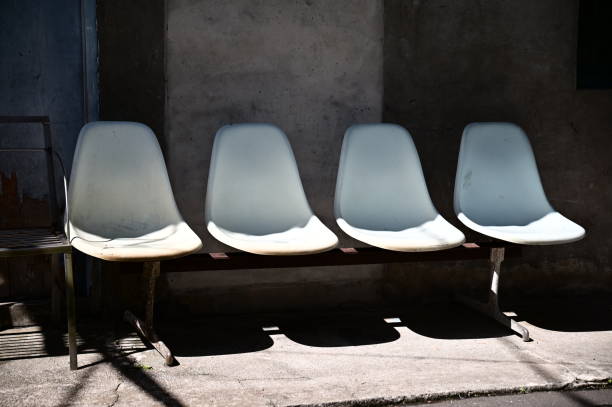 istock Plastic Waiting Chairs on Concrete with Sunlight 2195183958