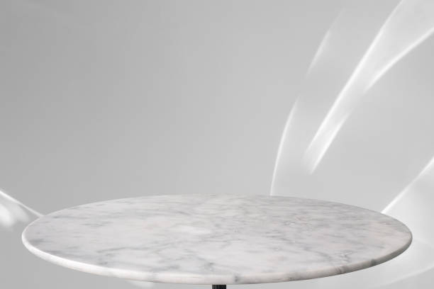 istock Round marble table top with abstract shadow drop on white wall background for mockup product display 2195187661