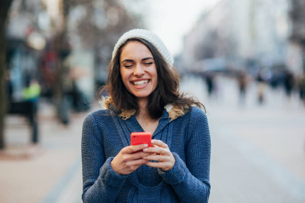 istock Young woman texting outdoors 2195187734