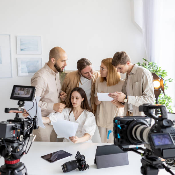 istock Media team paper work group people video discuss 2195188492