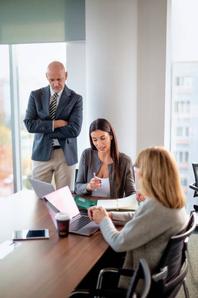 istock Business people communicating at desk in a modern office 2195188530