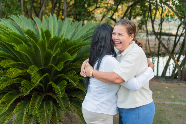 istock Two happy multi generational women hugging each other in a park 2195189473