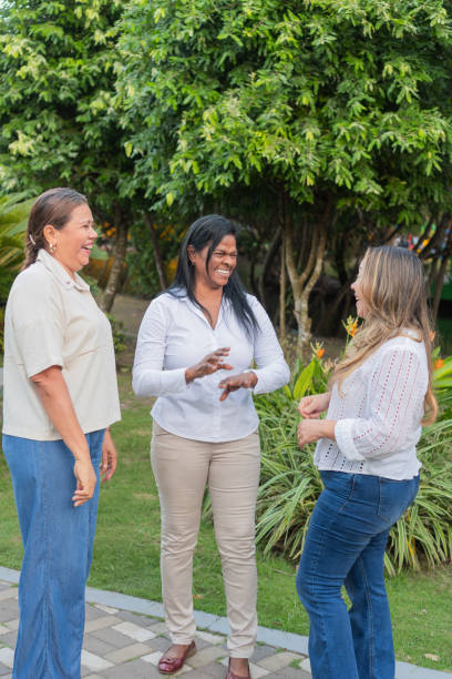 istock Three cheerful women laughing together in a park 2195189752