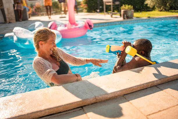 istock Diverse Couple's Water Fun with Squirt Gun 2195190683