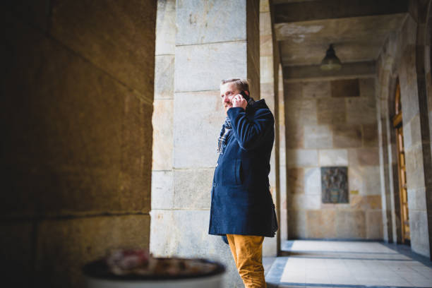 istock Businessman Talking on Phone in Corridor 2195190762