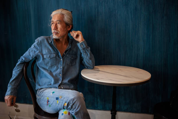 istock Senior man sitting in cafe 2195191635