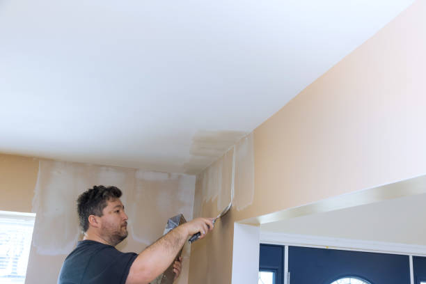 istock Man painting a ceiling in a modern interior space during a home improvement project 2195191765