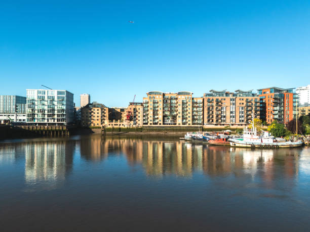 istock Modern buildings reflecting on the river thames in london, england 2195192078