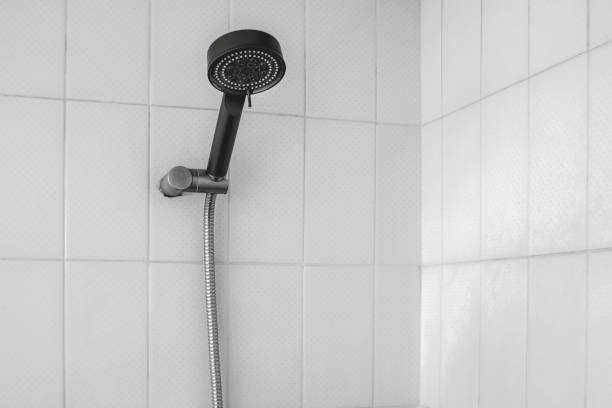 istock Black shower head on bathroom wall 2195192471