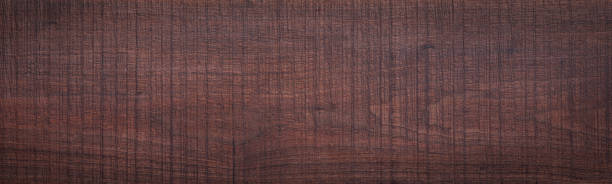 istock Rough sawn textured walnut wood plank texture background. Old walnut wood plank texture background. Rough walnut wood texture. wood texture background 2195193335