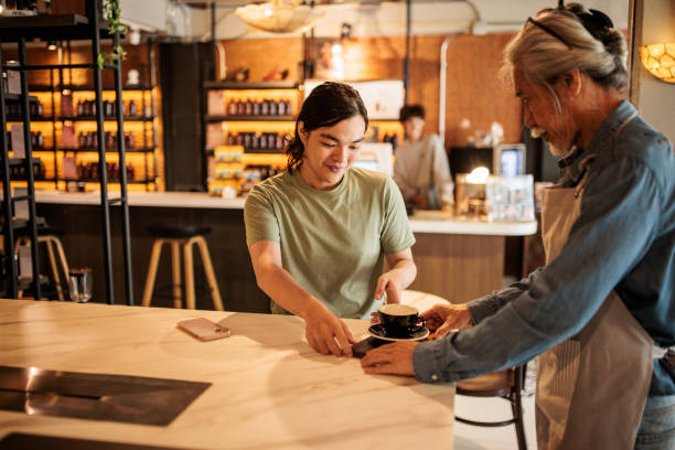 istock Waiter serving coffee to customer 2195193465