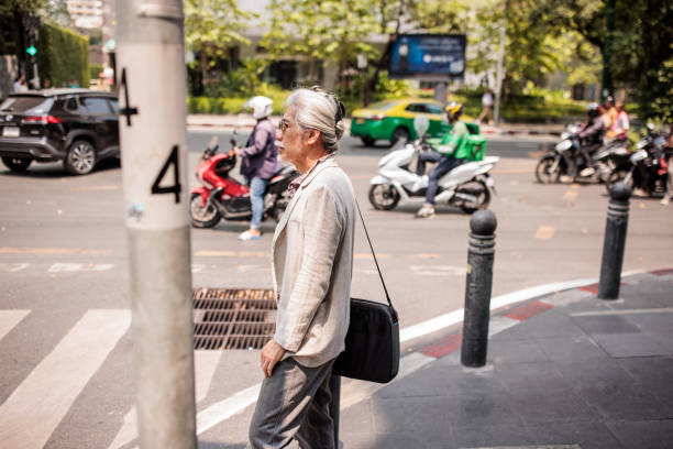 istock Elderly Thai Man in Downtown Bangkok 2195194138