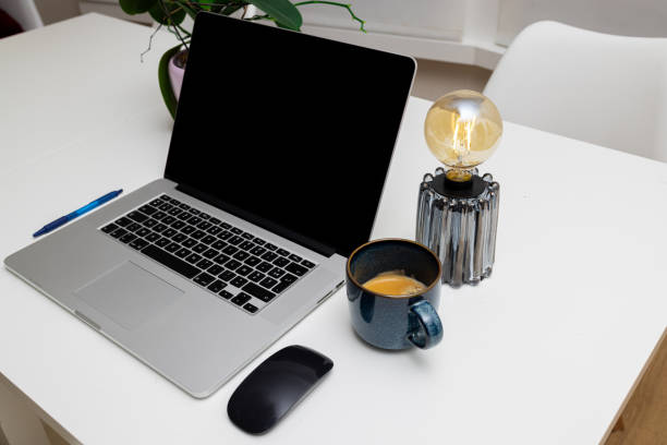 istock Stylish Workspace with Laptop, Coffee Mug, Pen, and Lamp 2195196634