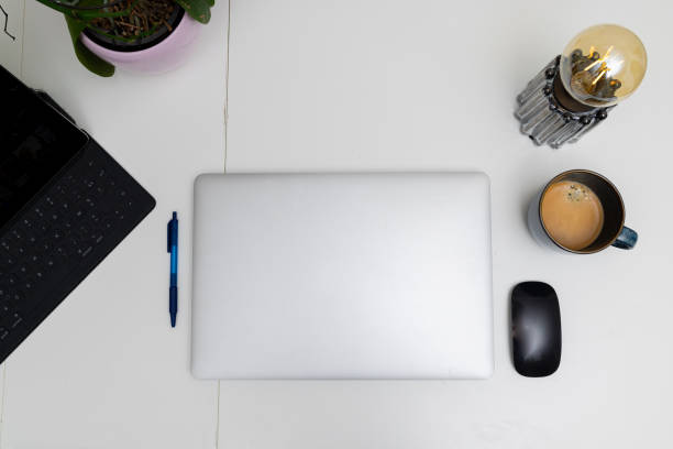 istock Organized Workspace with Laptop, Coffee Mug, and Decorative Lamp 2195196638