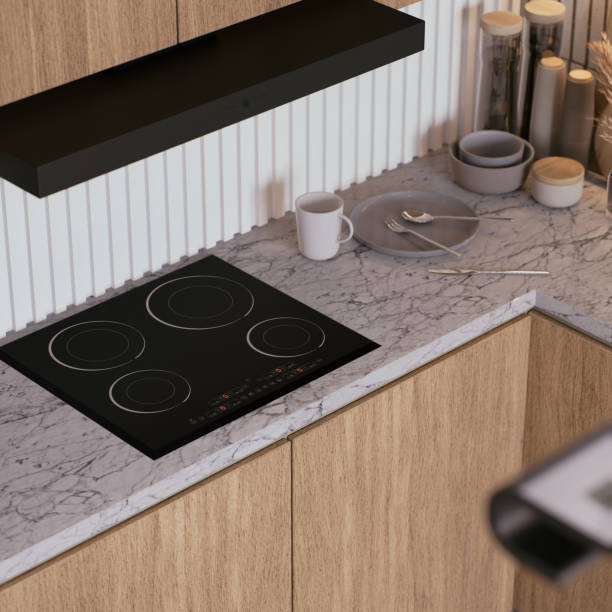 istock A modern kitchen featuring a sleek induction cooktop, minimalist cabinetry, and stylish countertop accessories in a warm, inviting design. 3d rendering. 2195198383