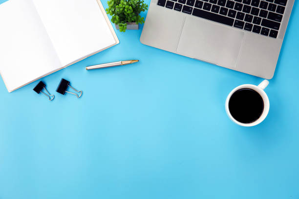 istock Top view desk office workspace and laptop and supply equipment with empty copy space for freelance working productive workplace area or home office flat lay background. 2195200093