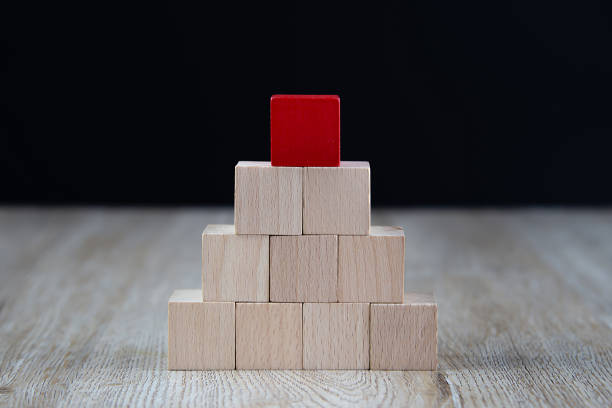 istock Cube wooden block toy stacked in pyramid shape on Blue background without graphics for Business design concept and activity  for child foundation practice skills. 2195200843