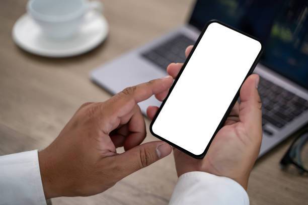 istock A man is holding a cell phone with a white screen 2195202210