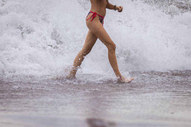 A woman is walking on beach after swimming.Canggu beach - Bali Island - Indonesia.